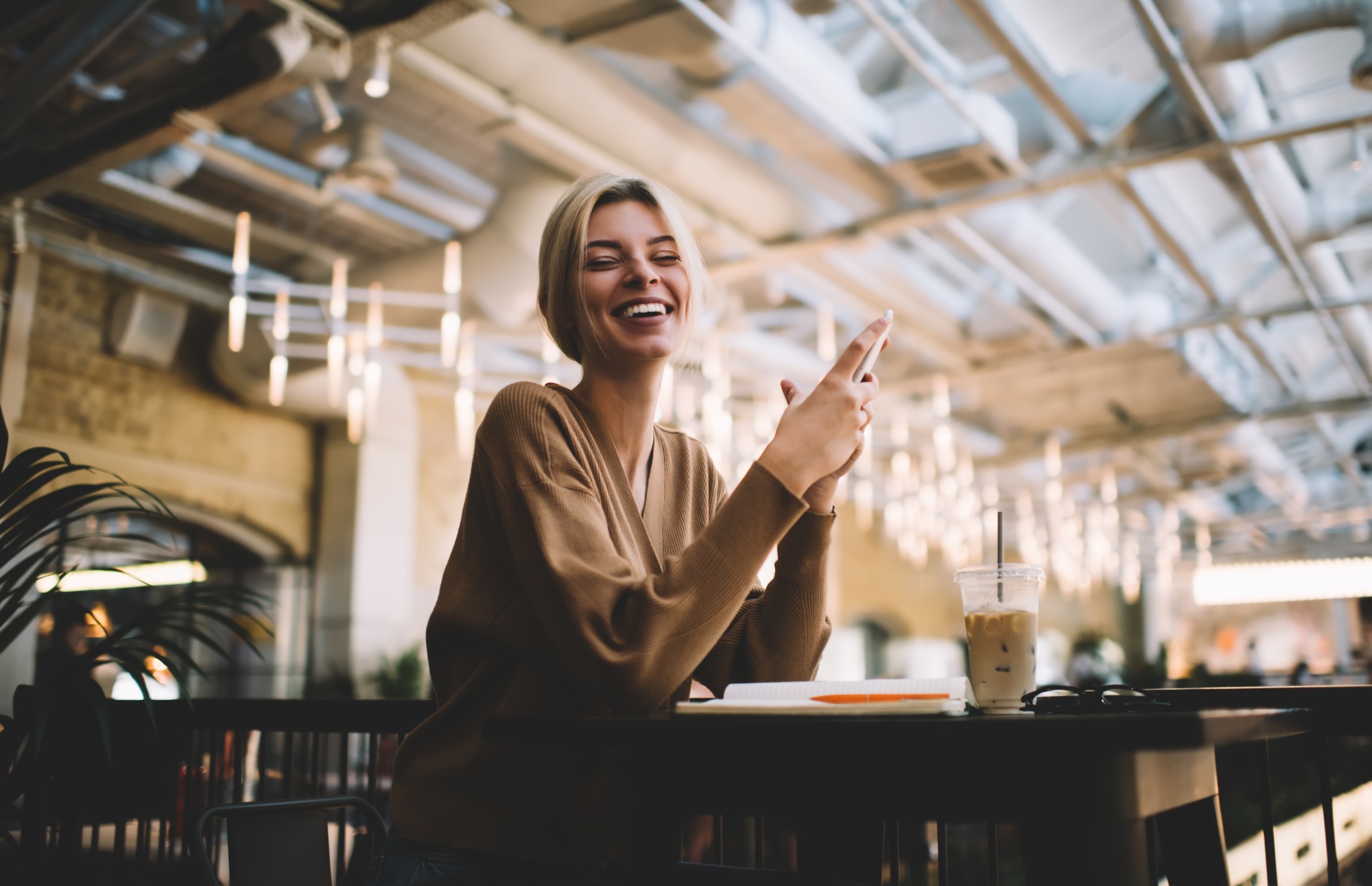 millennial hipster girl with smartphone posing while phoning